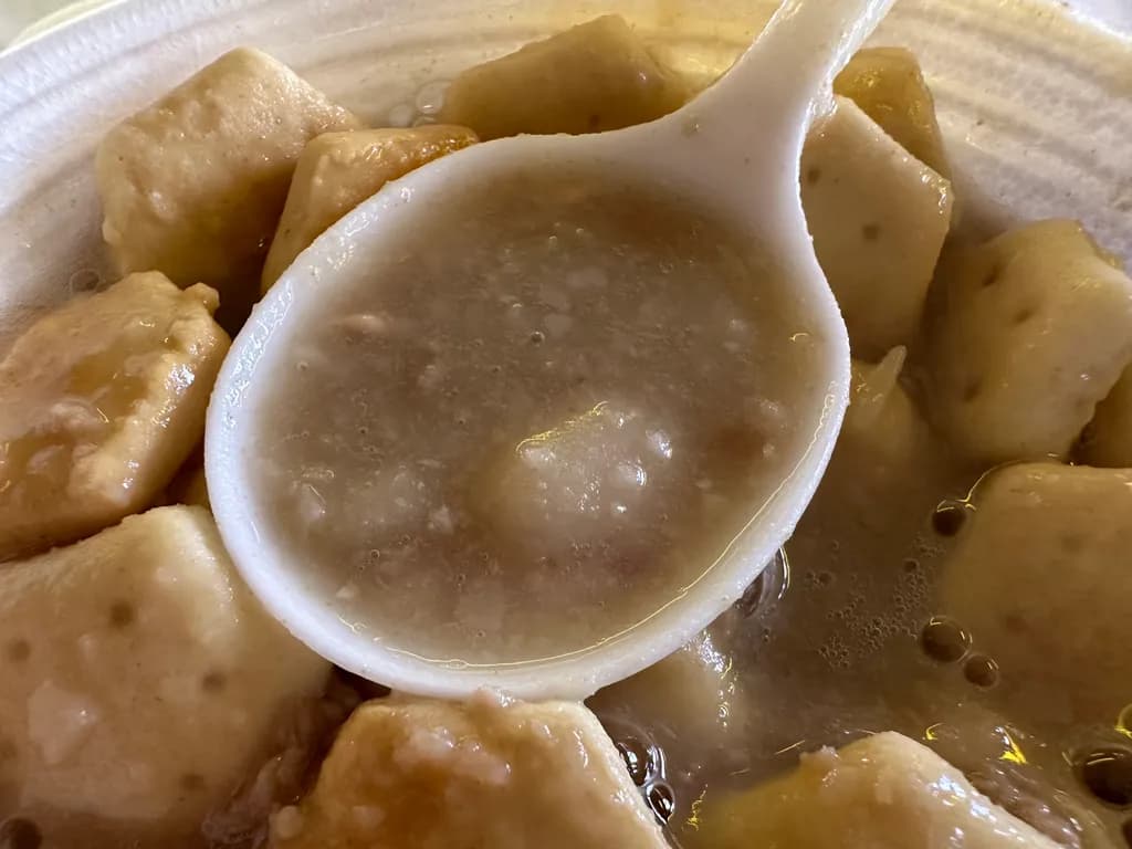 Savory Delights: A Bowl of Comforting Dumplings in Rich Broth