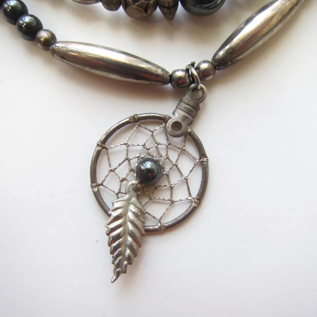 Dreamcatcher Elegance: A Silver Leaf and Hematite Charm Necklace for Spiritual Connection and Style