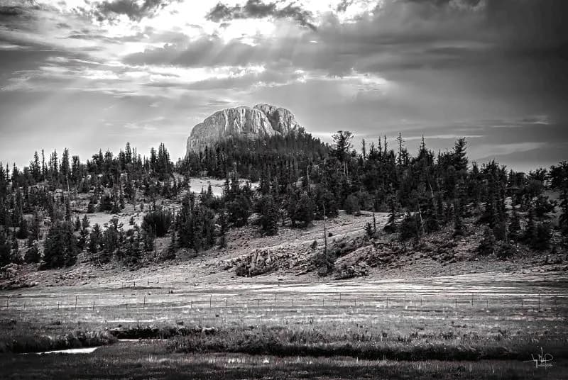 Serenity in Monochrome: A Majestic Mountain Landscape Under Cloudy Skies