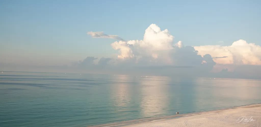 Serenity at Dawn: A Tranquil Beachscape with Gentle Waves and Whispering Clouds