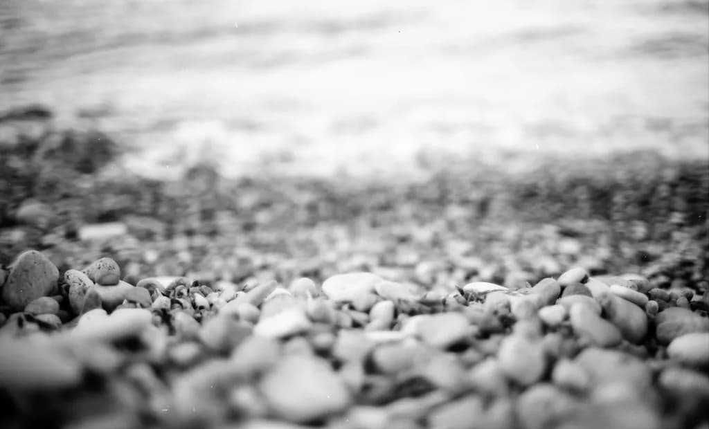 Whispers of the Shore: A Playful Dance of Pebbles and Waves