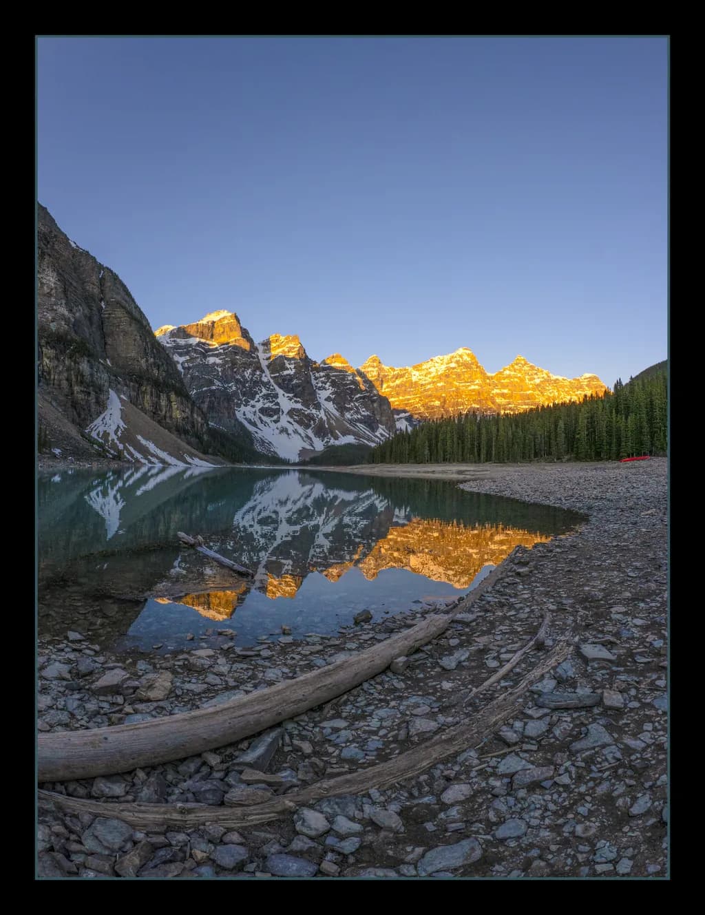 Golden Peaks Reflected: A Serene Morning at Moraine Lake