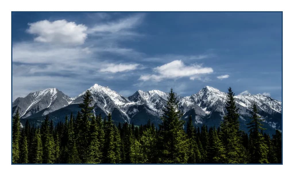 Majestic Peaks: A Serene Mountain Landscape Under a Blue Sky