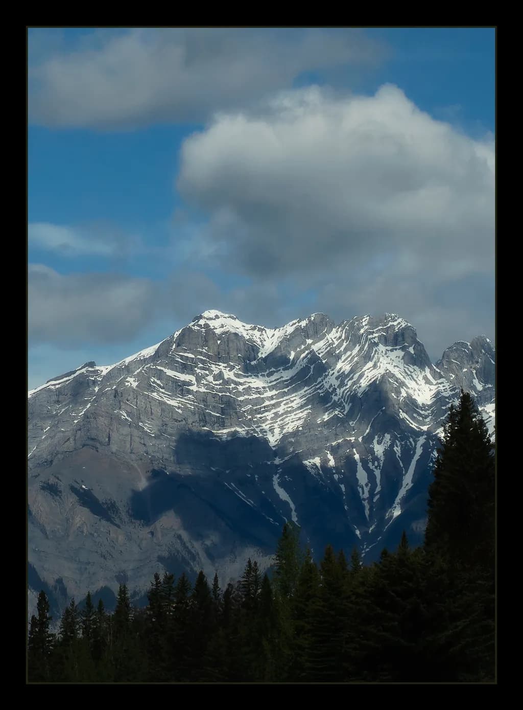 Majestic Peaks: A Serene Mountain Landscape Under a Cloudy Sky
