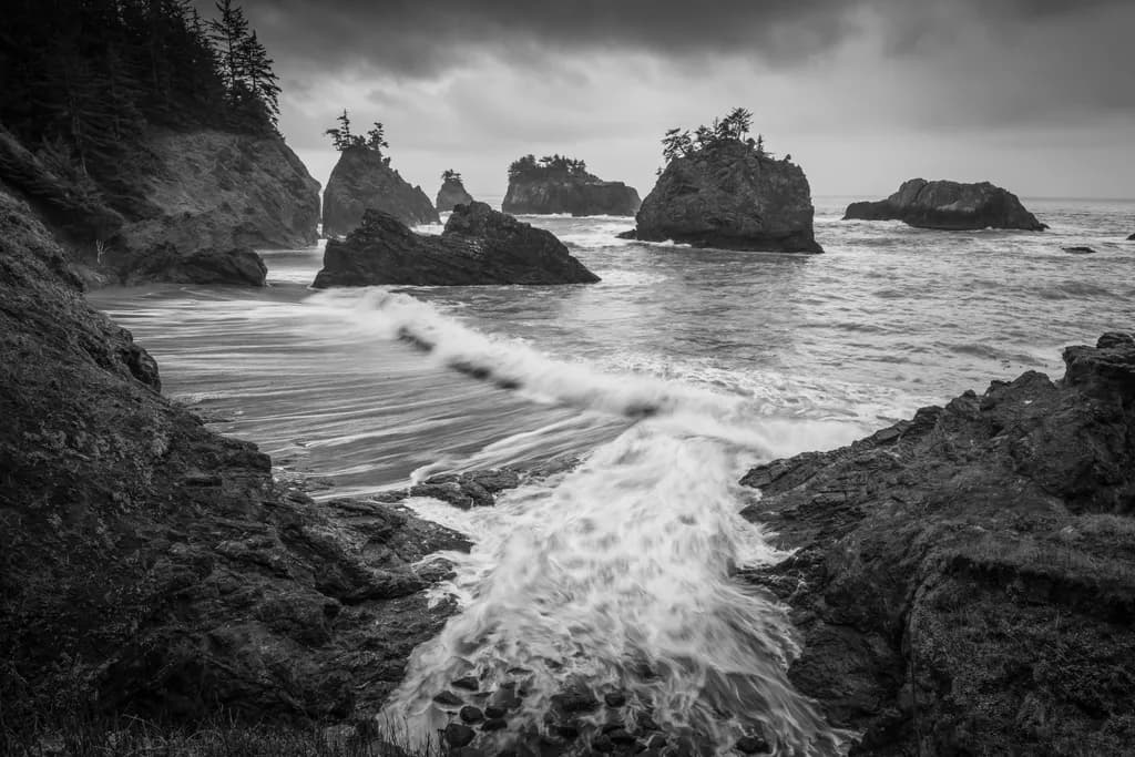 Whispers of the Ocean: A Serene Dance of Waves and Rocks in Monochrome