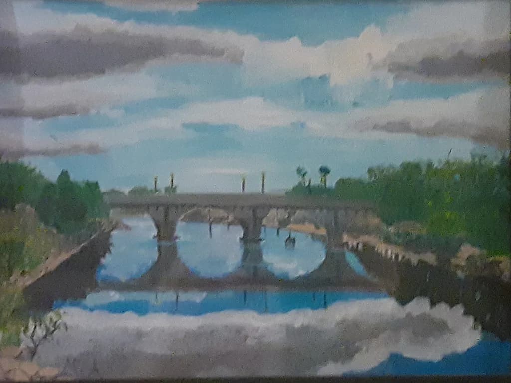 Reflections of Serenity: A Tranquil Bridge Under a Cloudy Sky