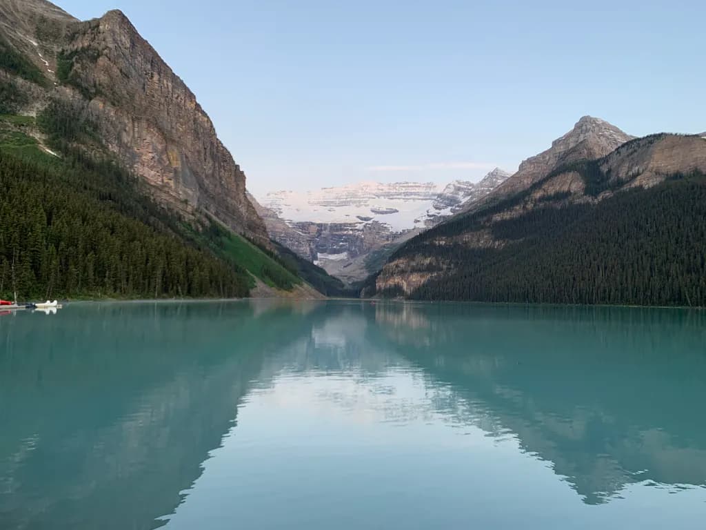 Serenity in Reflection: A Tranquil Mountain Lake Landscape at Dawn