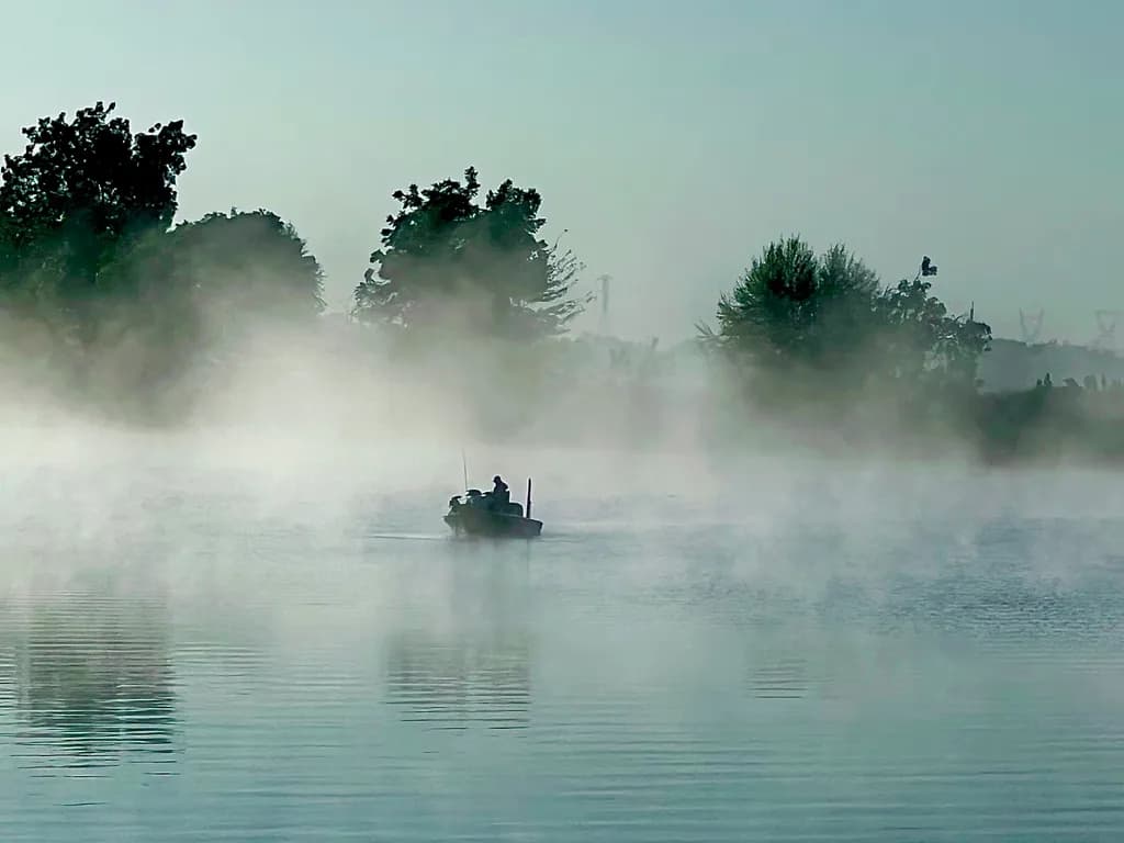 Whispers of Dawn: A Serene Morning on the Misty Waters
