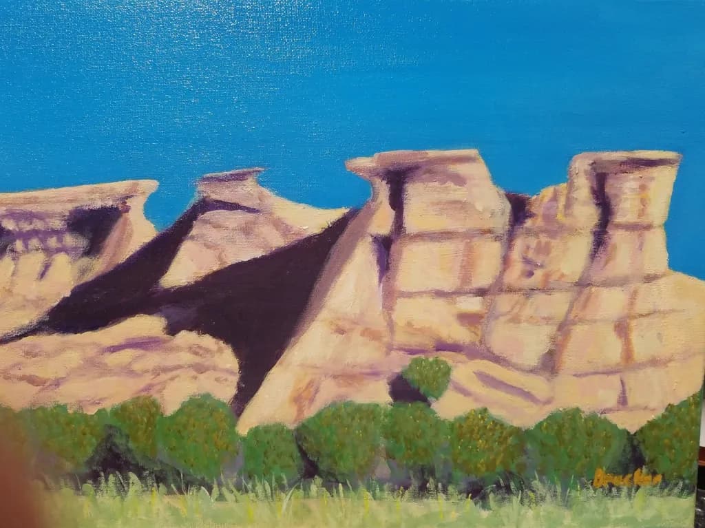 Whispers of the Canyon: A Vibrant Landscape of Majestic Rock Formations Under a Clear Blue Sky