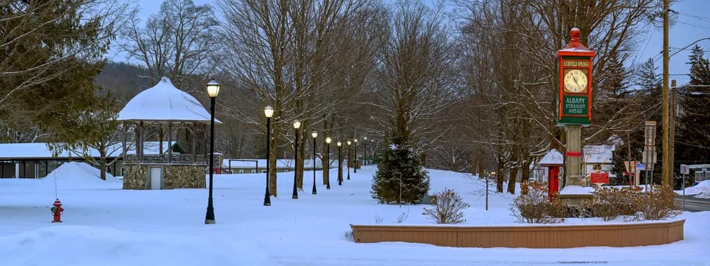 Snow Dusted Rural Park With Antique Town Clock and Bandstand
