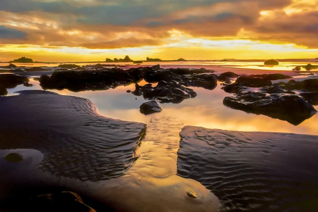 Serenity at Sunset: A Tranquil Reflection on the Beach Rocks