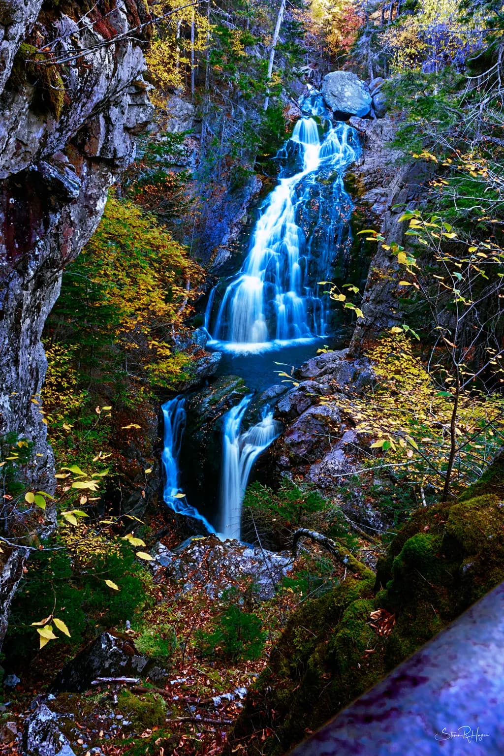 Whispers of Autumn: A Serene Waterfall Cascade in Vibrant Fall Colors