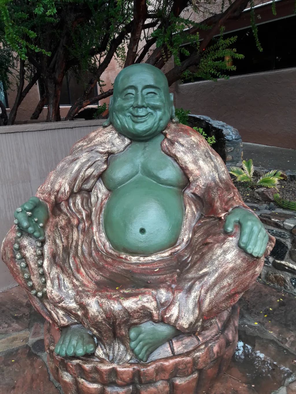 Serene Laughter: A Whimsical Buddha Sculpture Embracing Joy and Tranquility