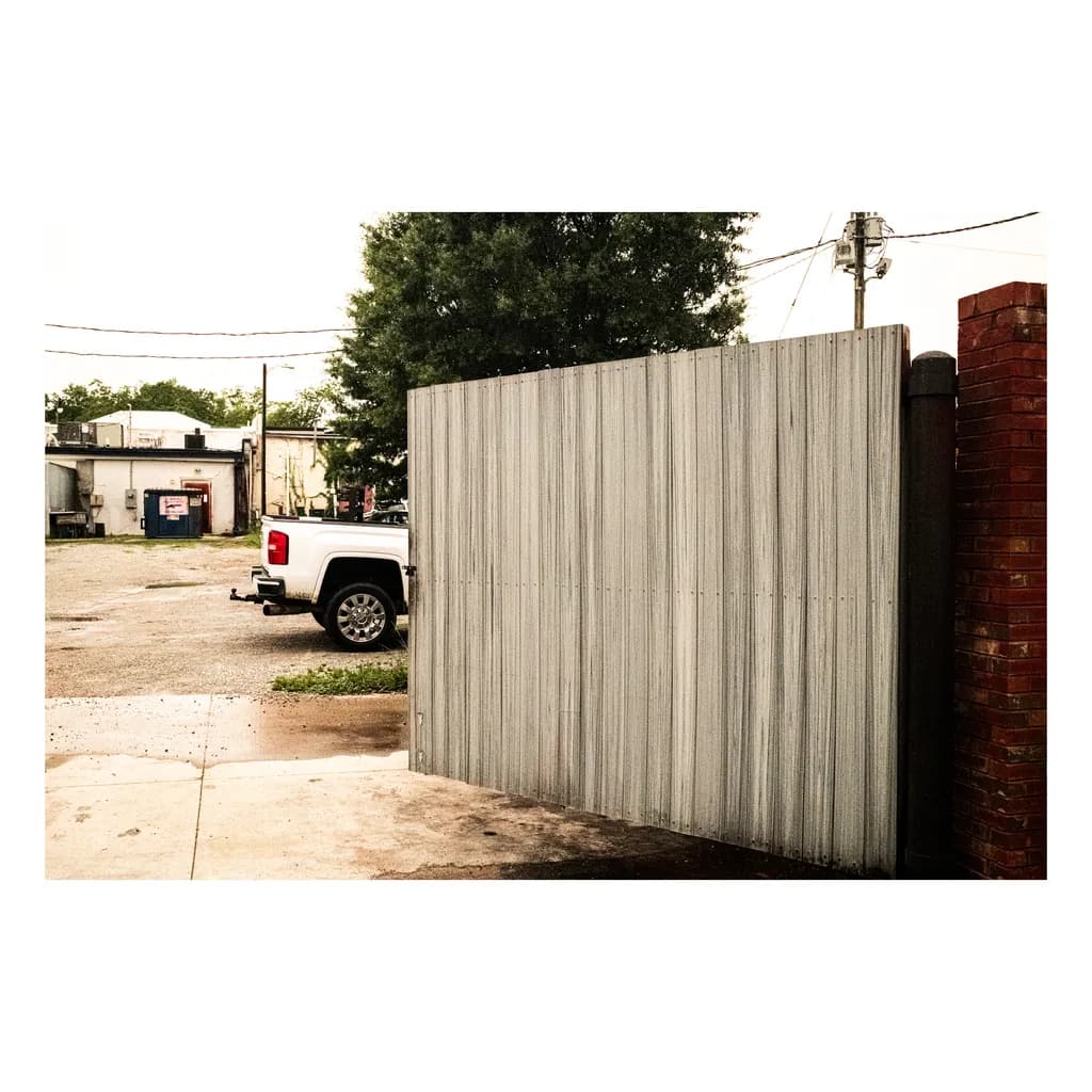 Truck by Brick Fence