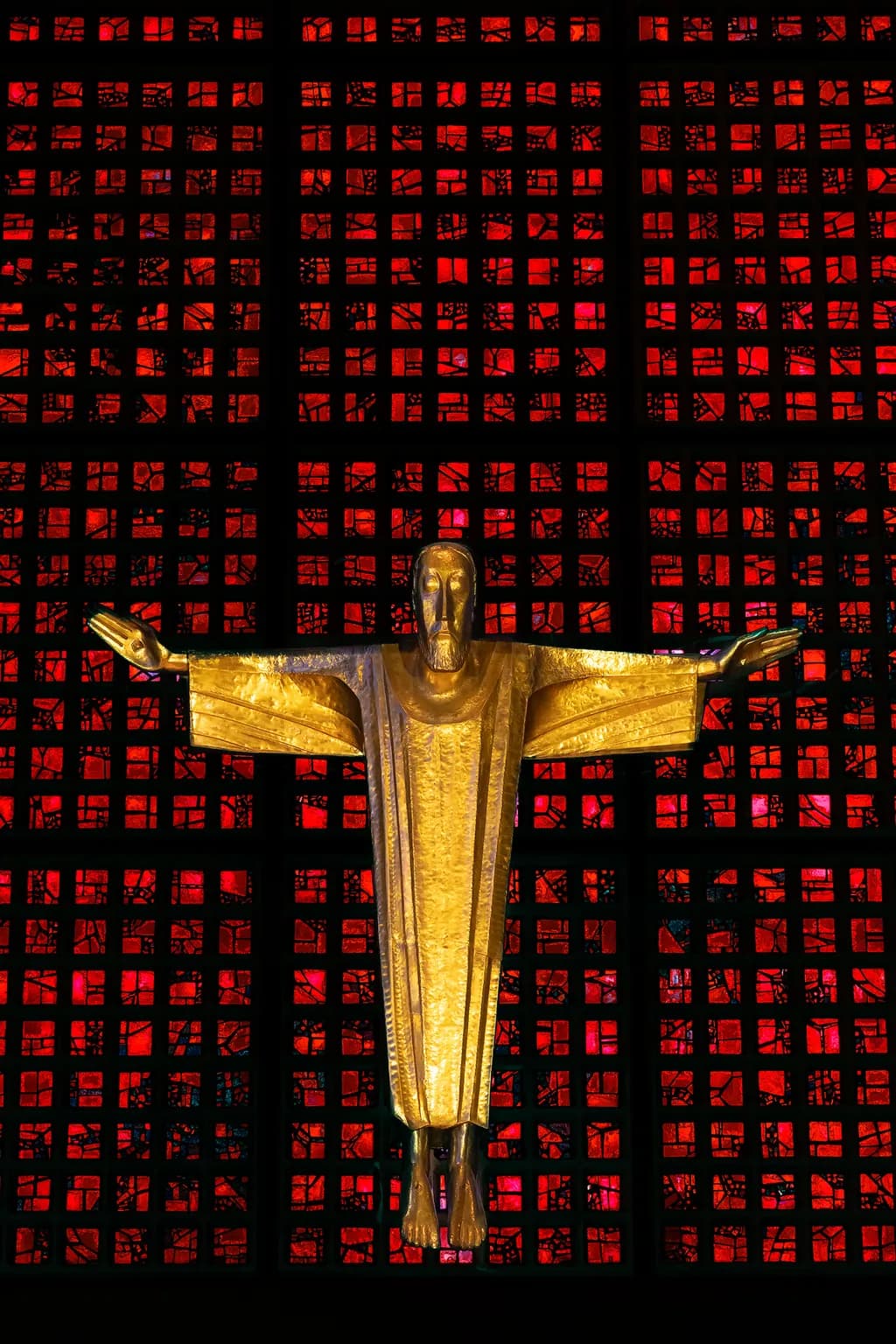 Golden Embrace: A Radiant Christ Against a Fiery Stained Glass Backdrop