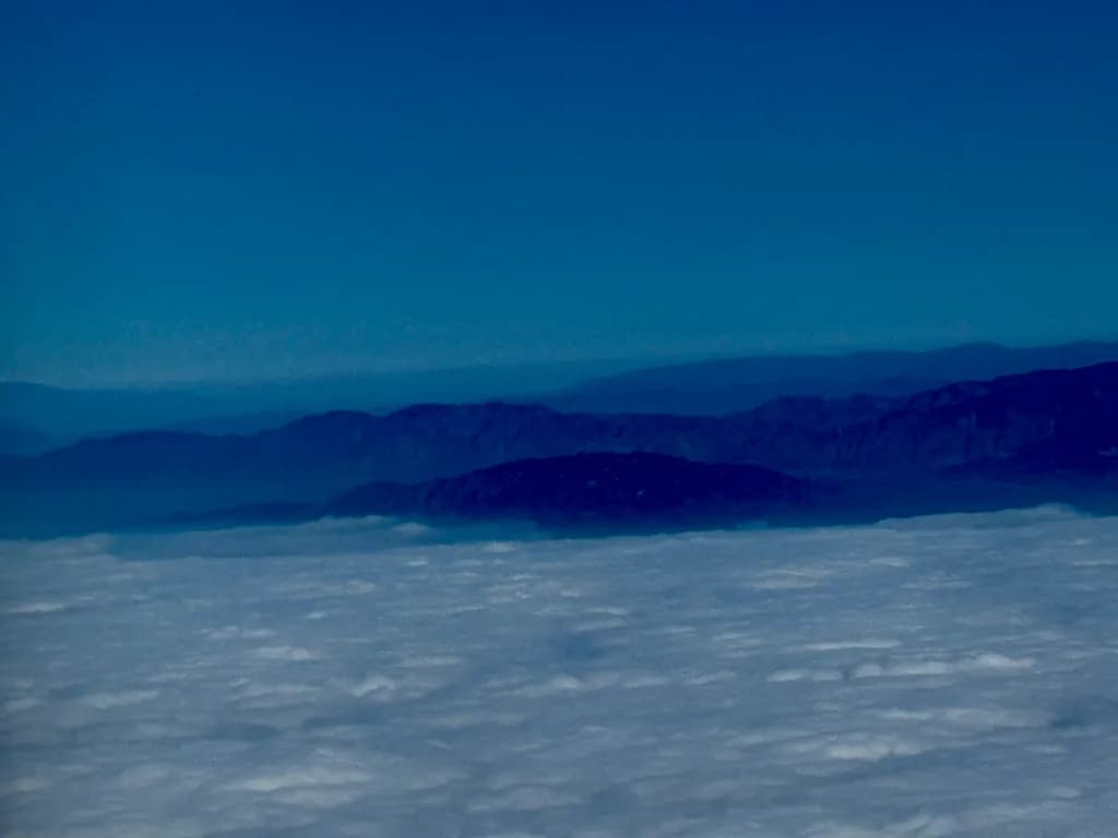 Mountain Ridges Above Clouds