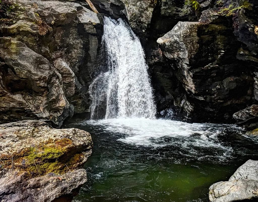 Whispers of the Waterfall: A Serene Cascade Amidst Ancient Stones