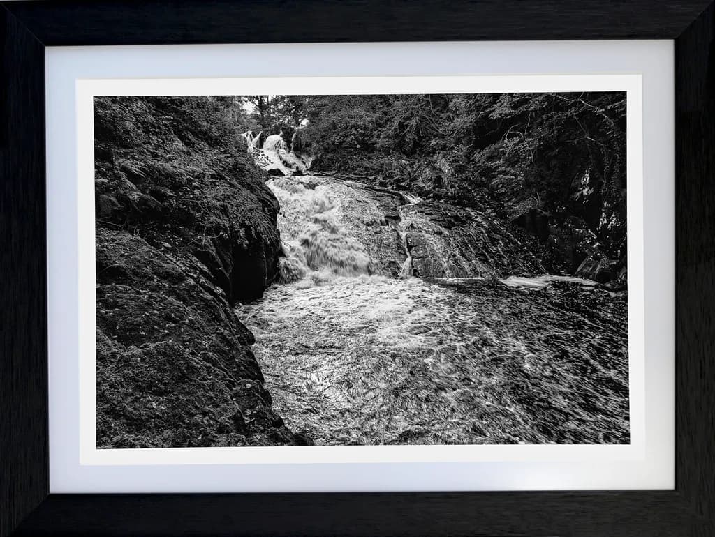 Whispers of the Waterfall: A Black and White Dance of Nature's Flow