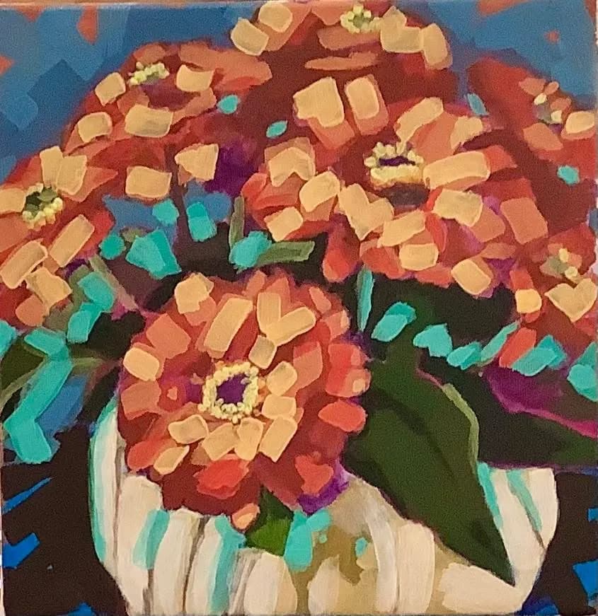 Vibrant Blooms: A Colorful Celebration of Zinnias in a Striped Vase