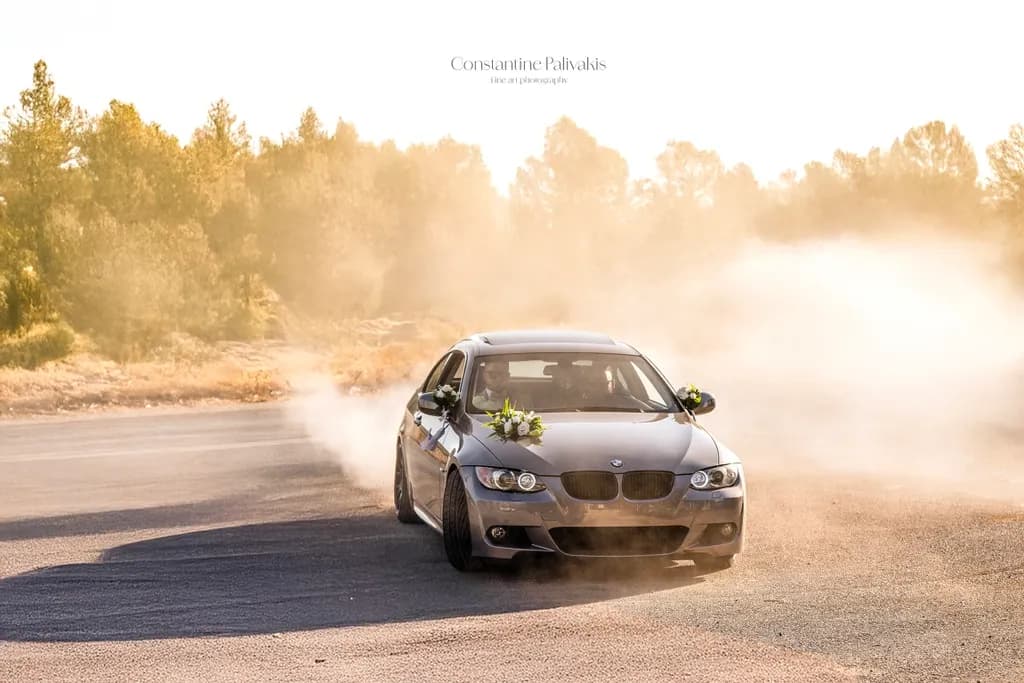 "Elegance in Motion: A BMW's Dance Amidst Dust and Sunlight"