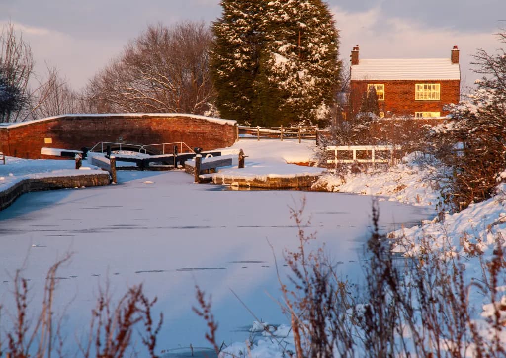Winter Serenity: A Tranquil Canal Landscape in Snowy Bliss