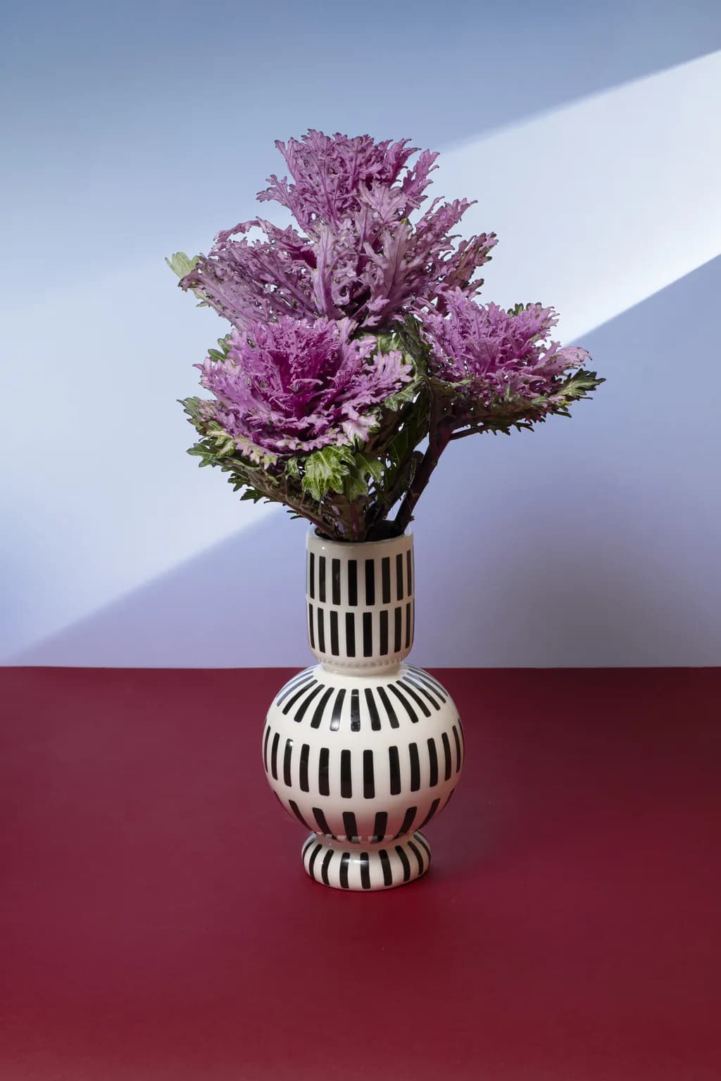 "Vibrant Harmony: A Modern Floral Still Life in Striped Elegance"