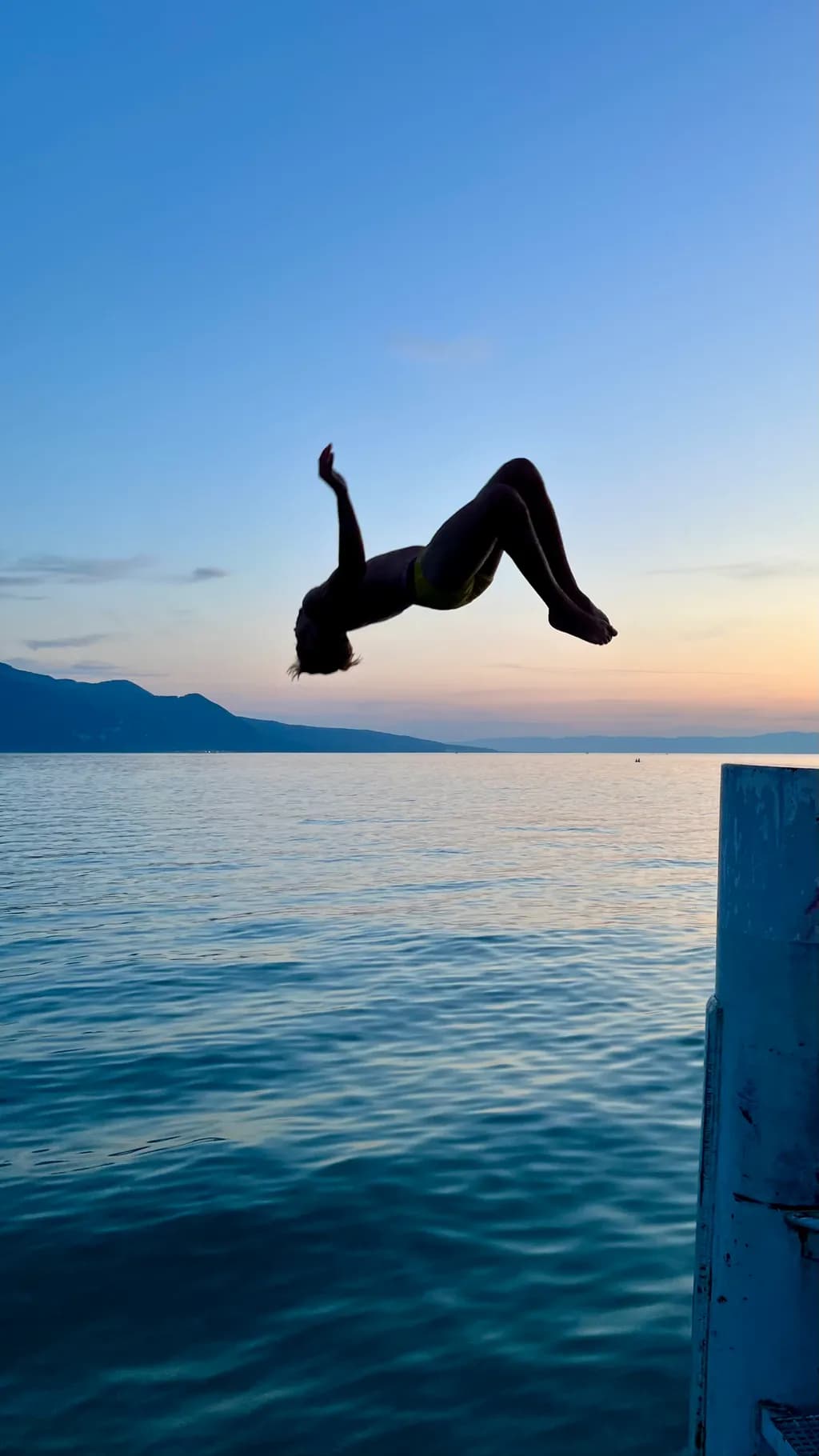 Ethereal Leap: Embracing Freedom at Sunset Over Tranquil Waters