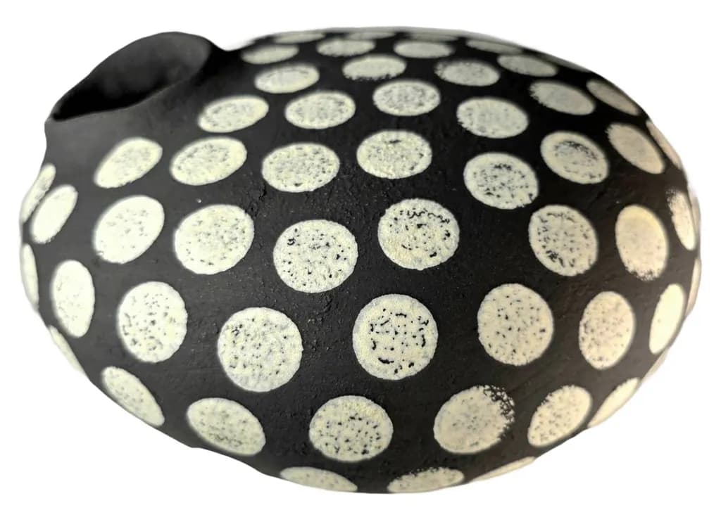Whimsical Harmony: A Playful Dance of Dots on Black Clay