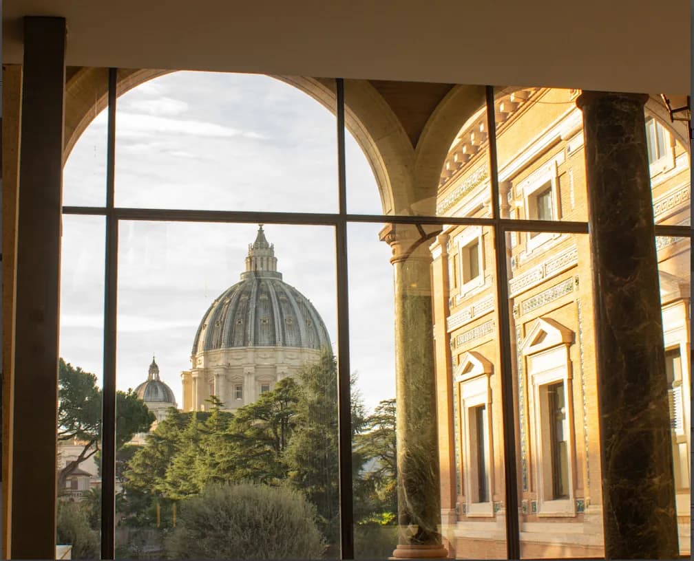 Ethereal View: The Majestic Dome of St. Peter's Basilica Framed by Architectural Elegance