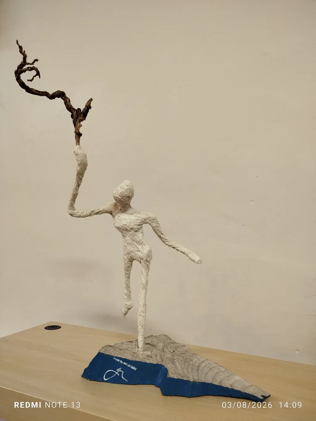 Figure with Twisted Branch