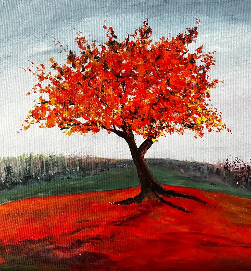 Vibrant Autumn Blaze: A Majestic Orange Tree in a Serene Landscape