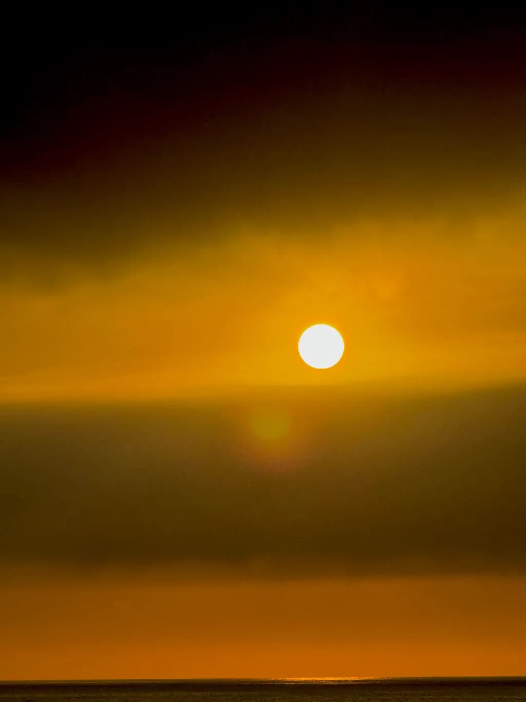 Serene Sunset: A Golden Reflection in the Sky