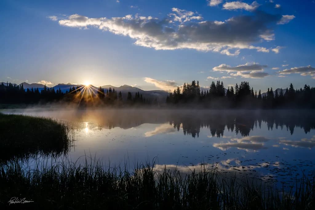 "Awakening Reflections: A Serene Sunrise Over Misty Waters"