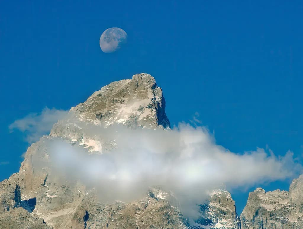 Whispers of the Moon: A Majestic Mountain Landscape Under a Clear Sky