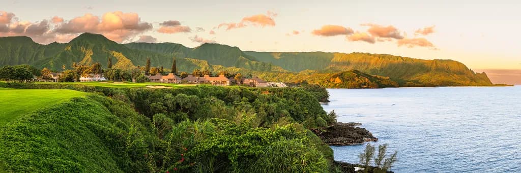 Serenity at Sunset: A Coastal Escape in Vibrant Greenery and Majestic Mountains