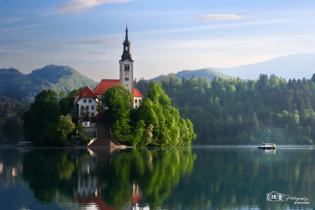 Serenity's Embrace: Reflections of a Church on Lake Bled's Tranquil Waters