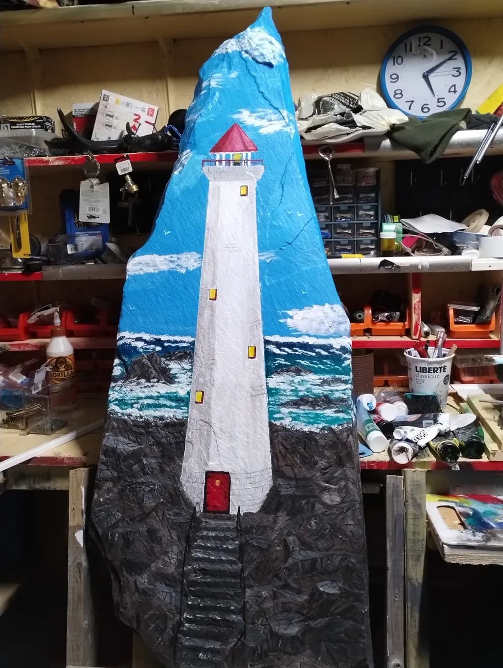 Beacon of Hope: A Vibrant Lighthouse Sculpture Amidst Turbulent Seas