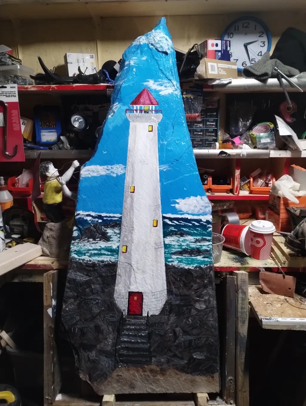 Guiding Light: A Coastal Lighthouse Carving in Vibrant Blues and Whites