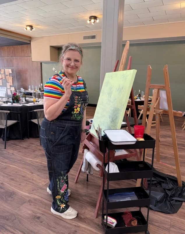Artist at work - painting during a live community art event.
