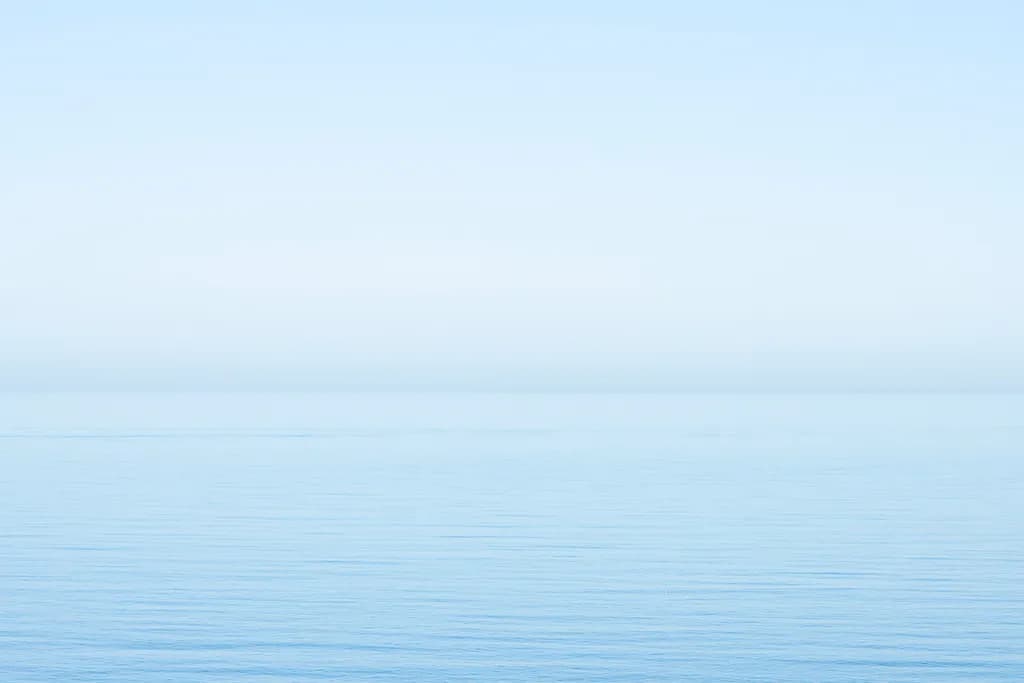 Serenity in Blue: A Tranquil Reflection of Calm Waters and Expansive Skies