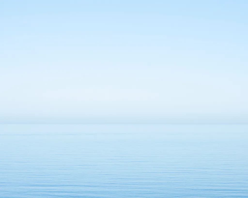 Serenity in Blue: A Tranquil Horizon Over Calm Waters