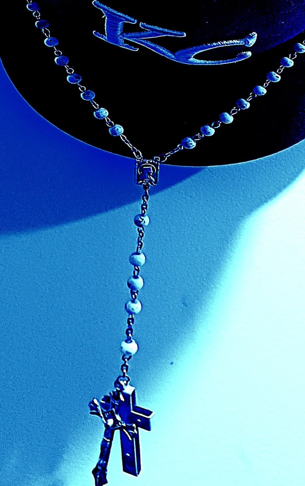 Ethereal Reflections: A Blue-Hued Rosary Pendant with Cross Charm