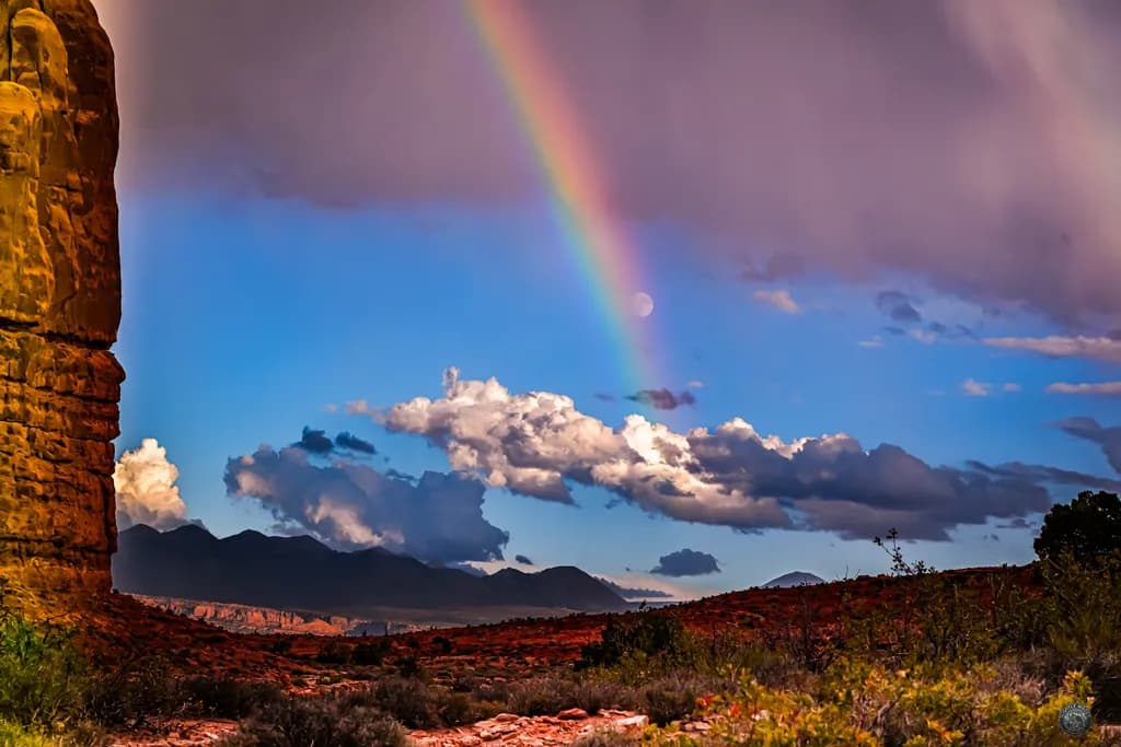 Rainbow Over Rugged Peaks