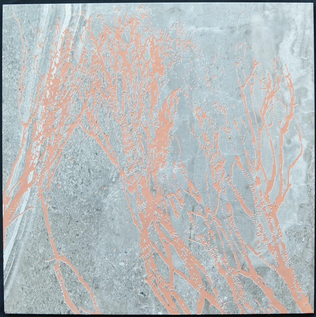 Laser engraving on a ceramic floor tile. 2019
