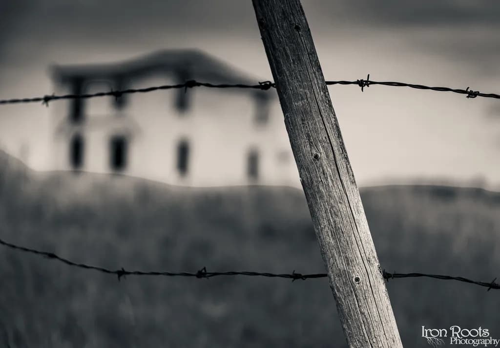Barbed Fence and House