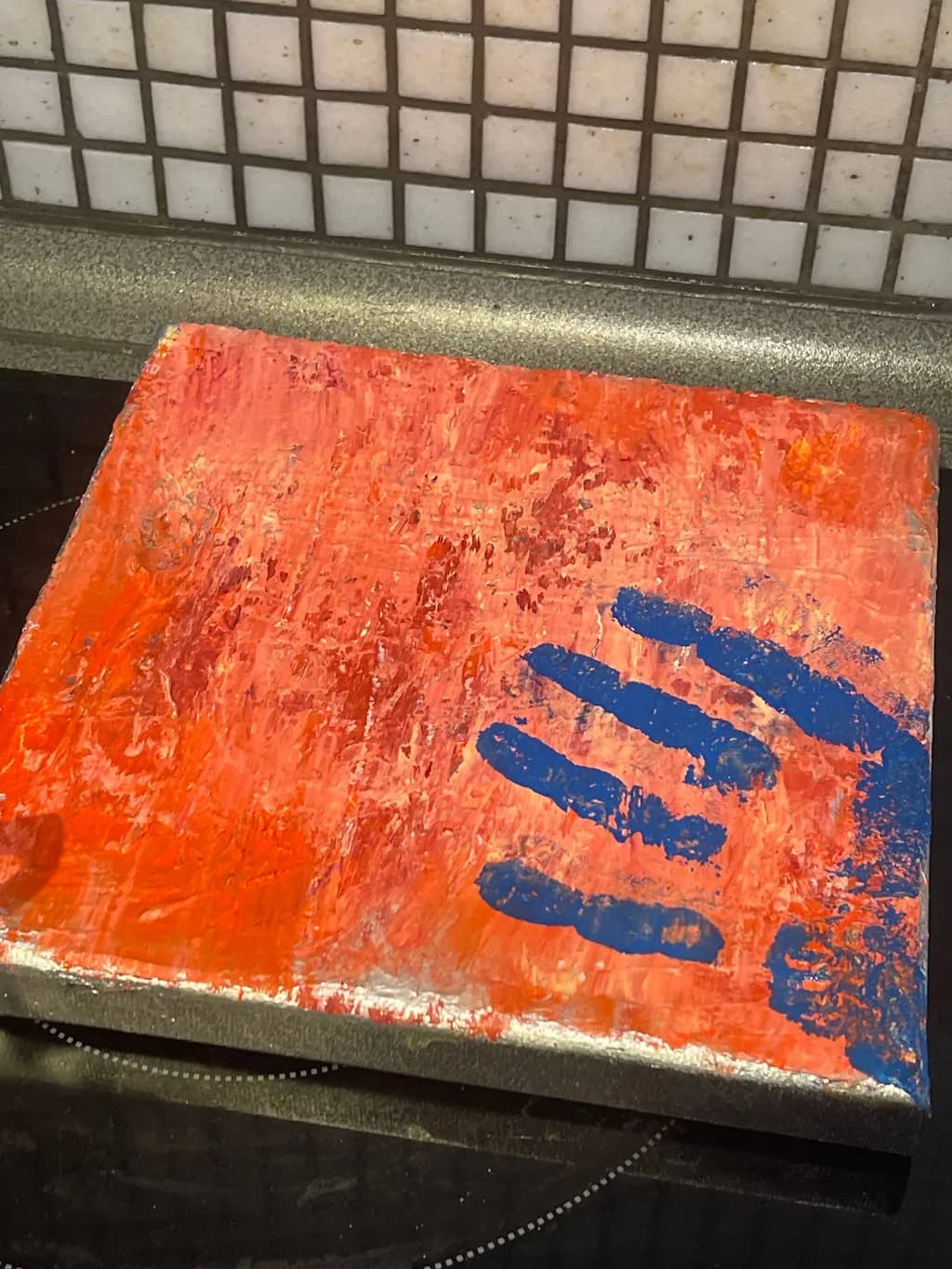 Blue Handprint on Orange Canvas