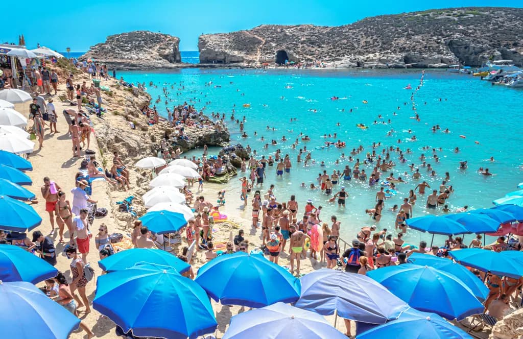 Beach Crowd and Blue Umbrellas