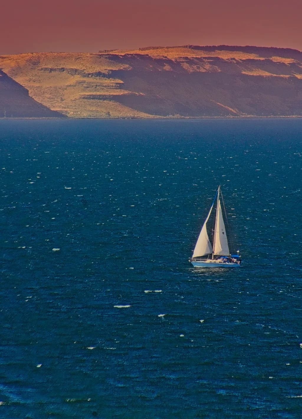 Deep Blue Water Sailing At Sunset