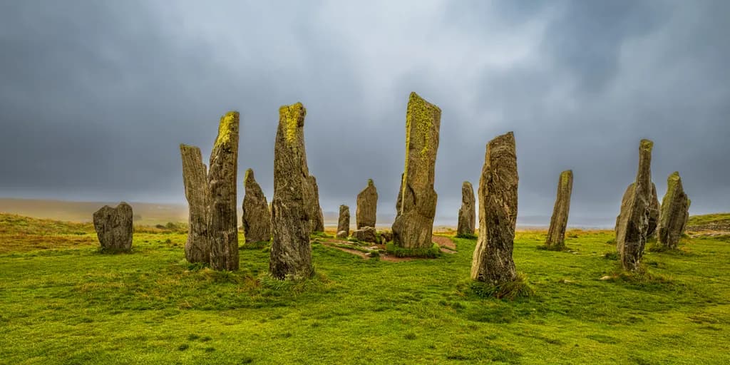 Mystical Ancient Stones: A Green Landscape Under Cloudy Skies