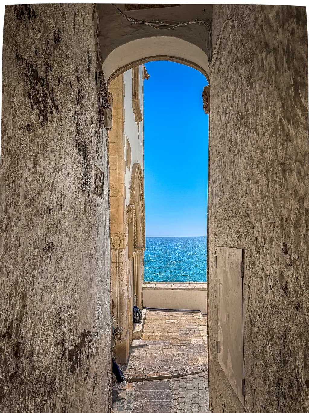 Serene Coastal Archway: A Tranquil View of Blue Horizons